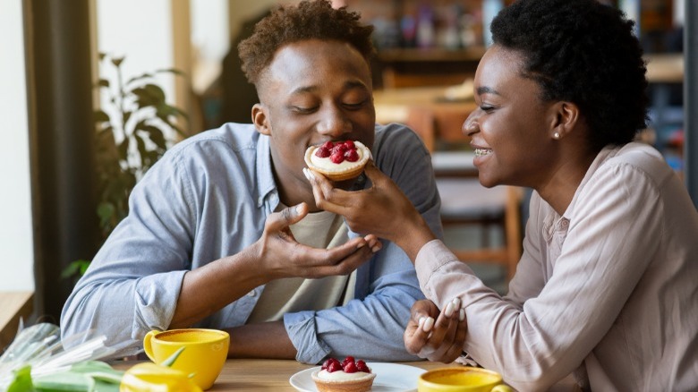 Couple sharing pastry on a date