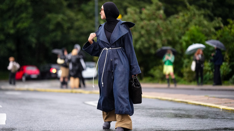 woman wearing denim maxi coat