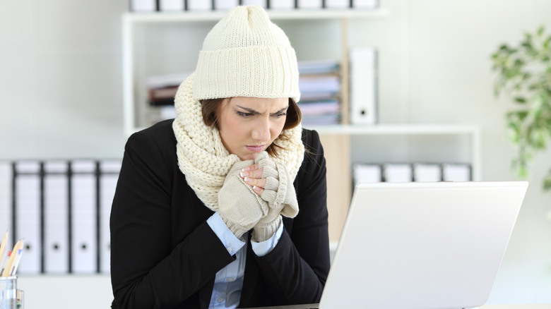 woman feeling cold in office
