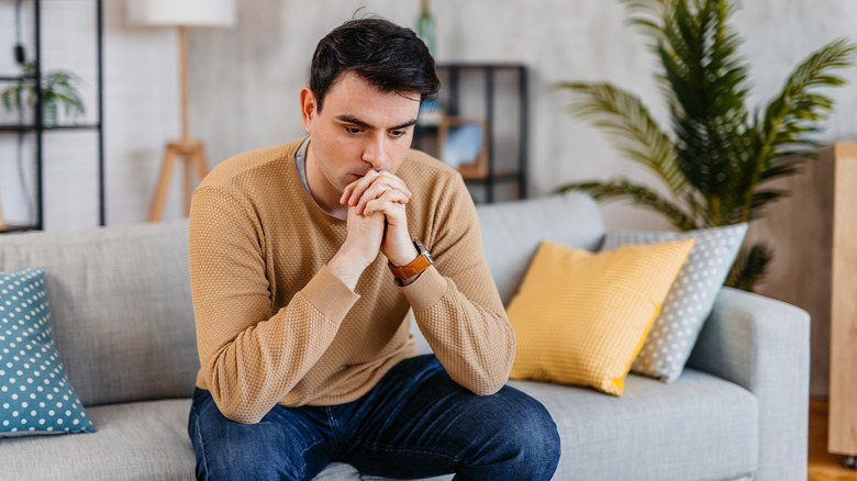 Depressed man on sofa