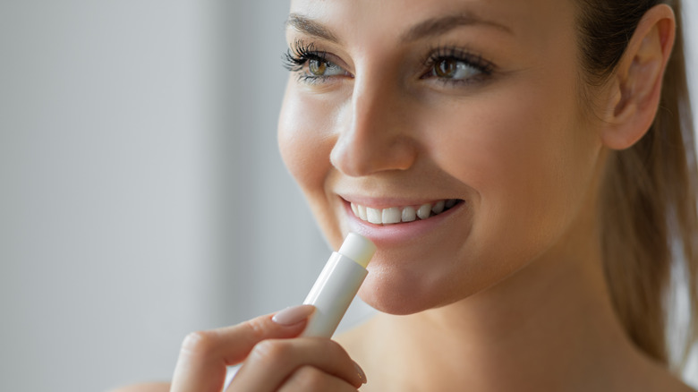 woman applying lip balm