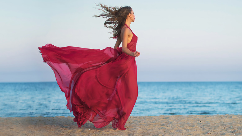 Girl wearing chiffon dress on a beach