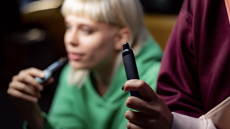 Young women vaping e-cigarettes