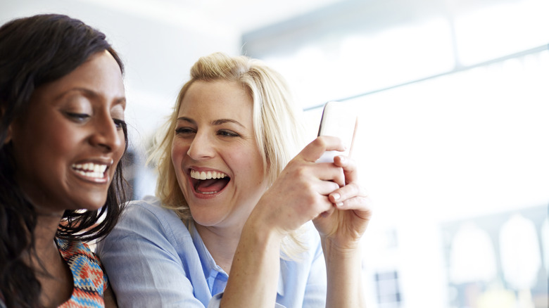 friends laughing at phone together