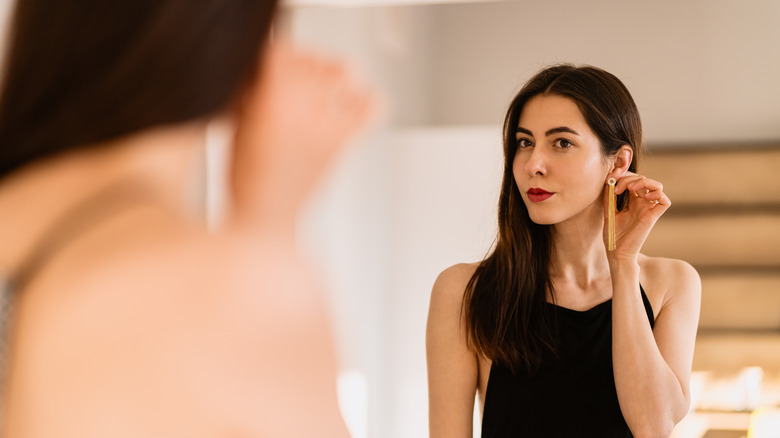 Woman trying on earring