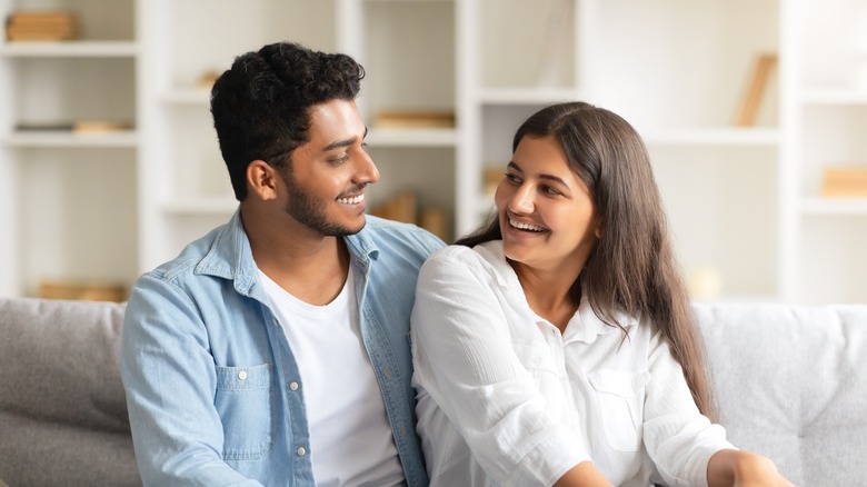 Man smiling at woman