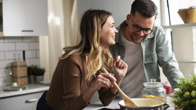 Couple cooking together in kitchen