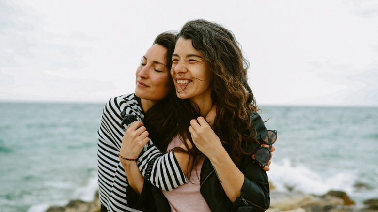 Two women hugging on beach