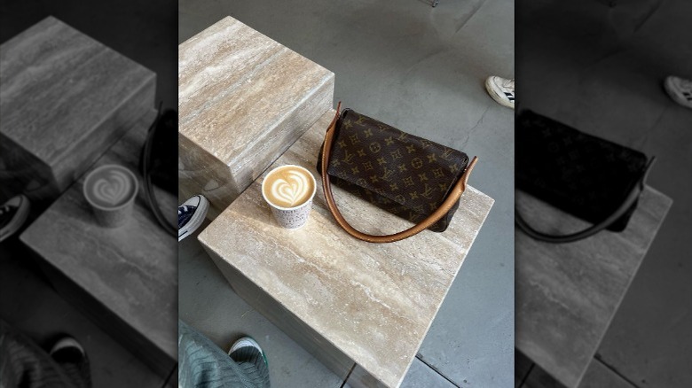 LV purse next to latte