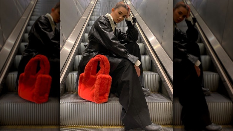 woman posing with red purse