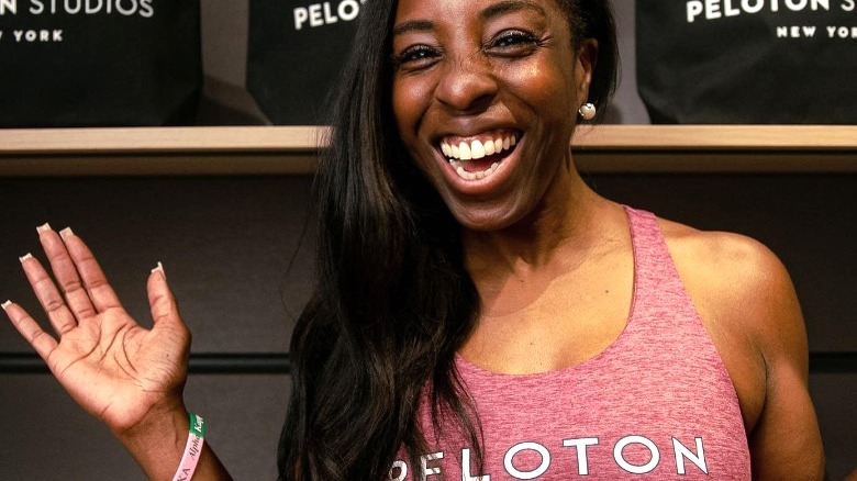 Smiling Black woman in Peloton gear