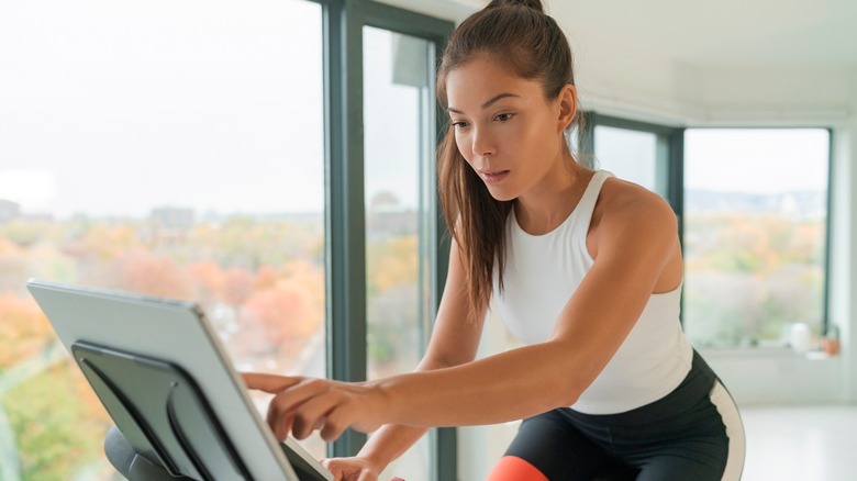 Asian woman on digital exercise bike