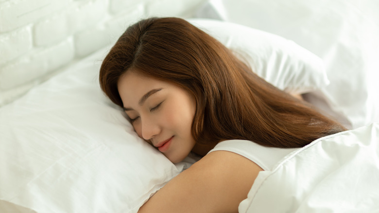 Smiling sleeping Asian woman