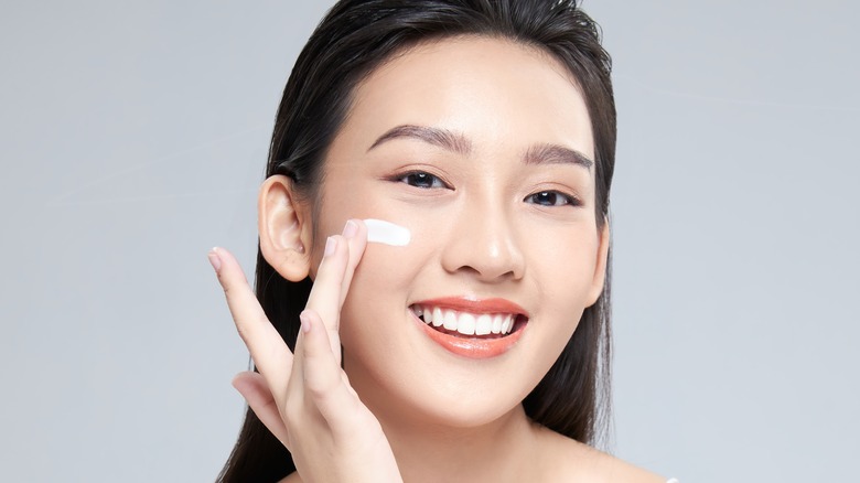 female apply cream to skin