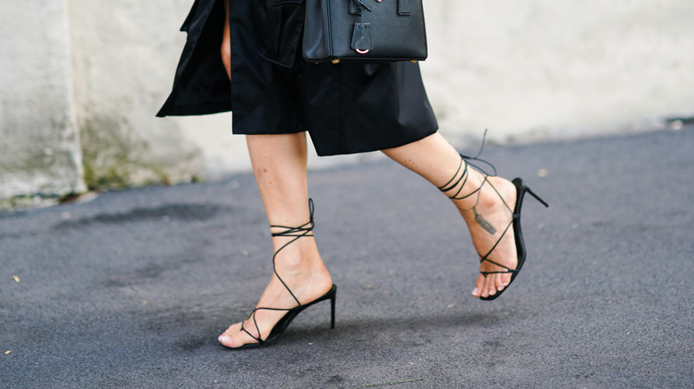 woman wearing black strappy heels