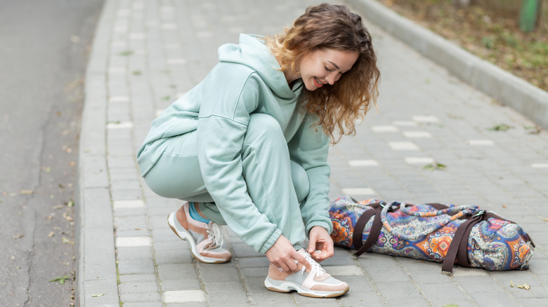 Woman tying athletic shoe