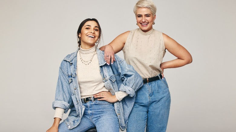Two women wearing jeans