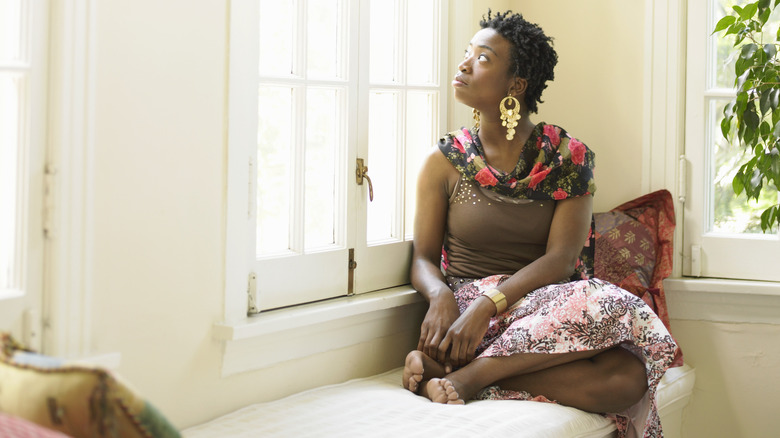 woman looking out window