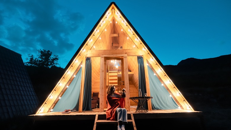 Woman holding kettle while glamping