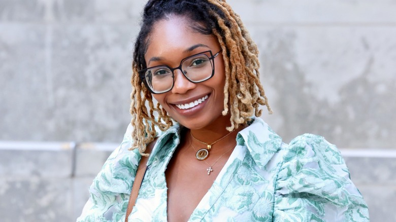 Ray'Chel Wilson wearing glasses and floral dress