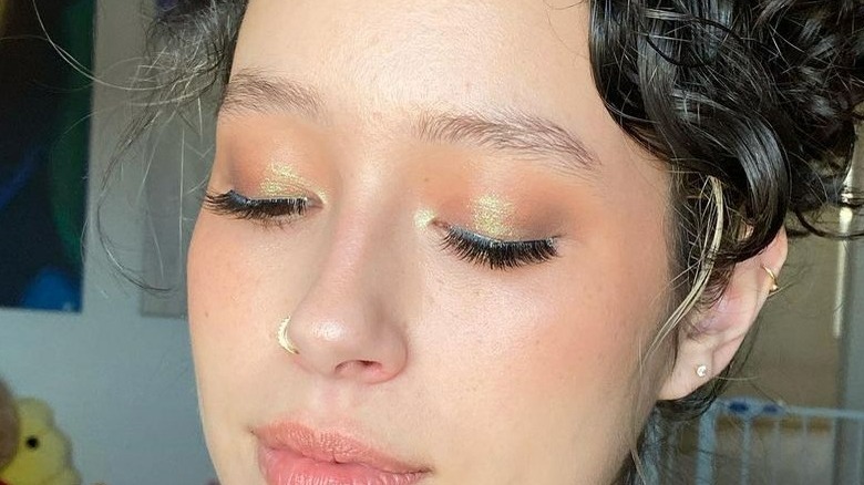 Person wearing sparkly bronze eyeshadow