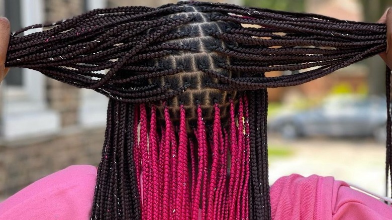 woman lifting braids