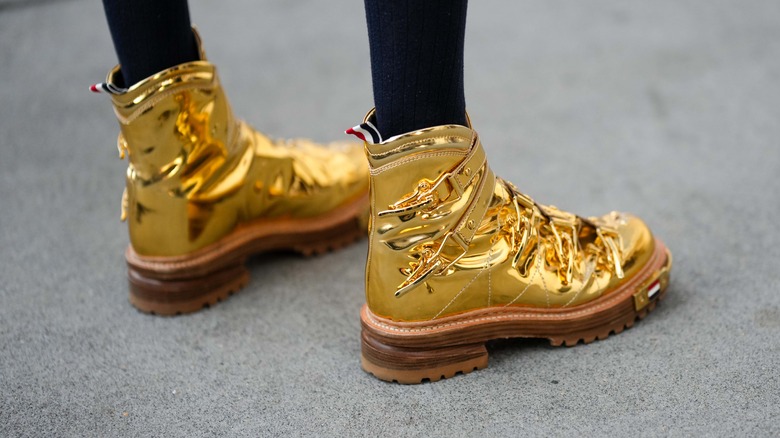 Man wearing gold shoes