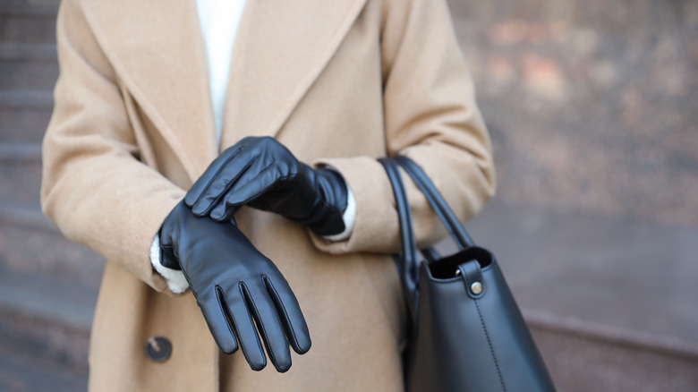 Woman wearing black gloves