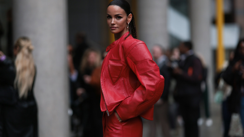 Woman wearing red leather jacket and skirt