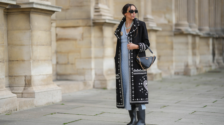 Woman wearing coat and long knit dress