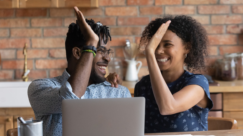 couple sitting in front of laptop