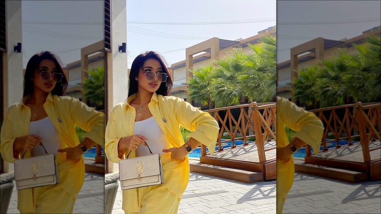 Woman wearing a yellow linen shirt and LV handbag