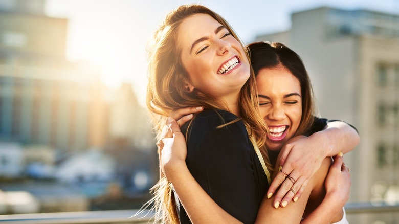 Two happy women hugging