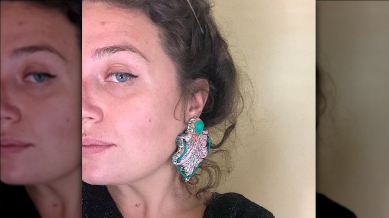 Woman wearing artsy earrings