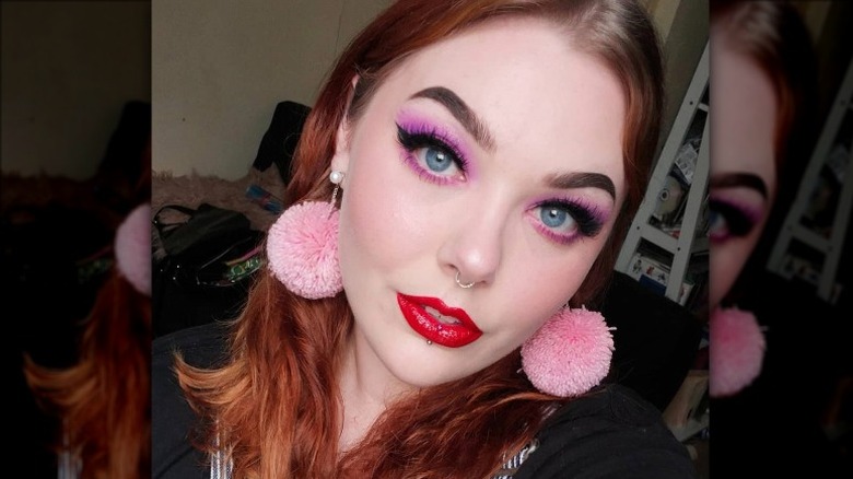 Woman wearing pom-pom earrings