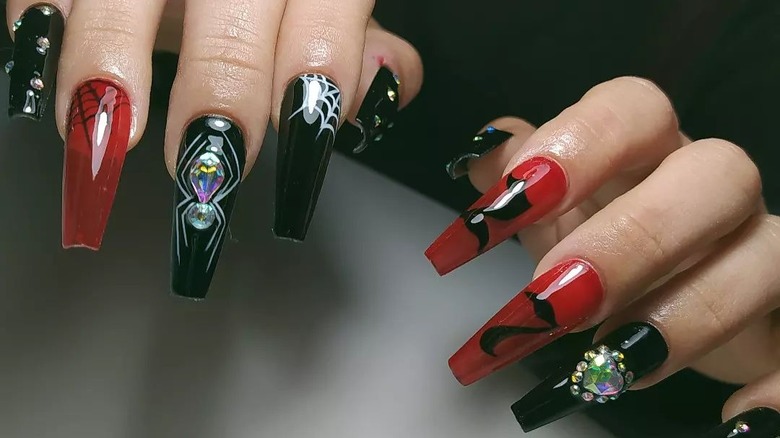 red and black manicure with spider decals