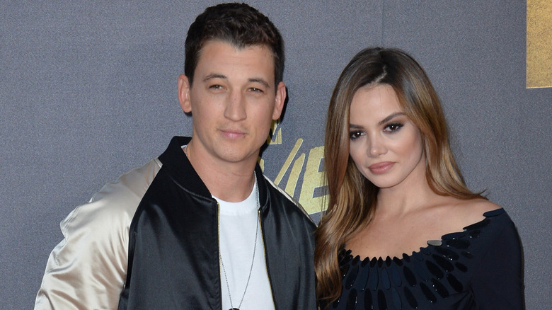 Miles Teller and Keleigh Sperry posing on a red carpet.