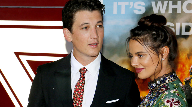 Miles Teller and Keleigh Sperry posing together on a red carpet.