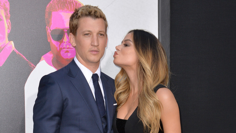 Keleigh Sperry giving Miles Teller a red carpet kiss.