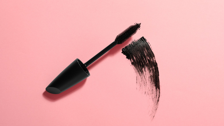 black mascara on pink background