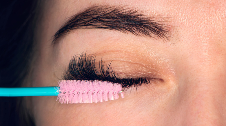 combing eyelashes with clean spoolie