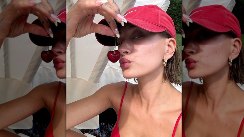 Hailey Bieber holding cherry