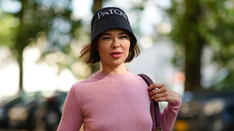 woman wearing black bucket hat