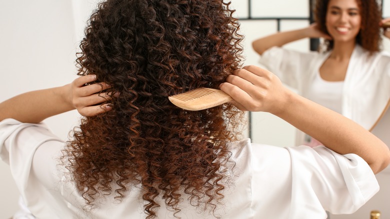 woman combing her hair