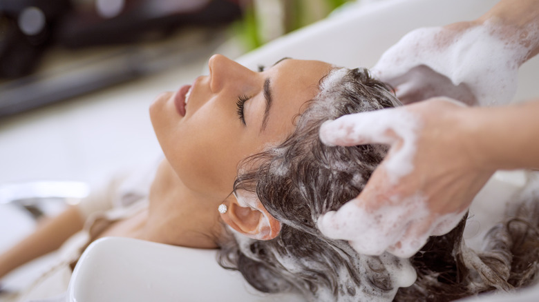 washing woman's hair at salon