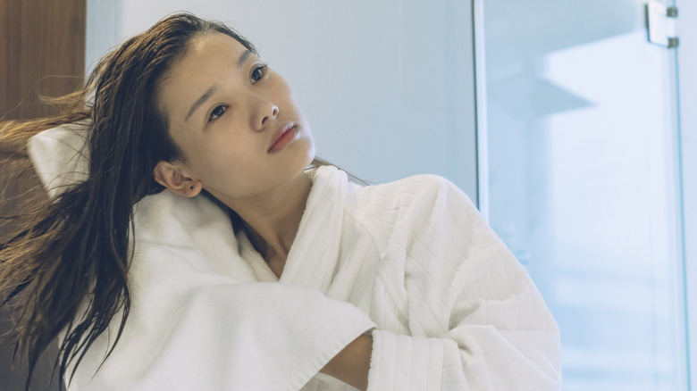 woman towel drying straight hair