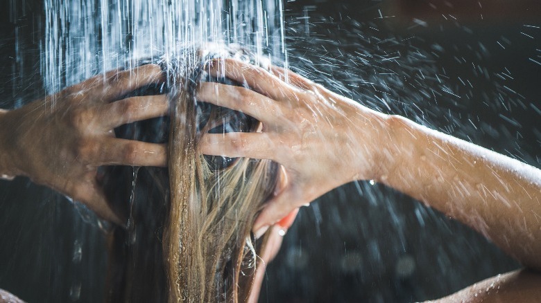 Person washing hair under shower