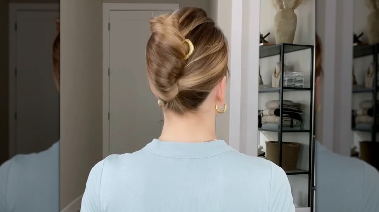 A woman wearing a French twist