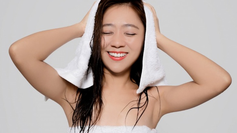Woman drying hair after shower