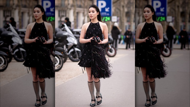 woman wearing black halter mini dress